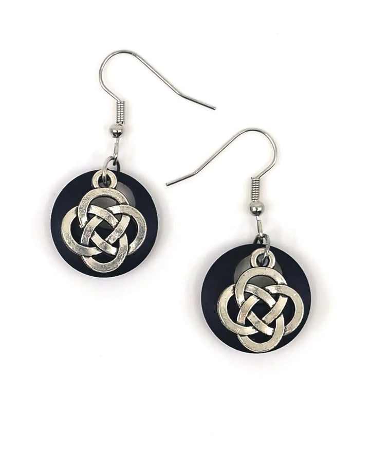 Celtic knot earrings with silver-tone charm on black timber backing