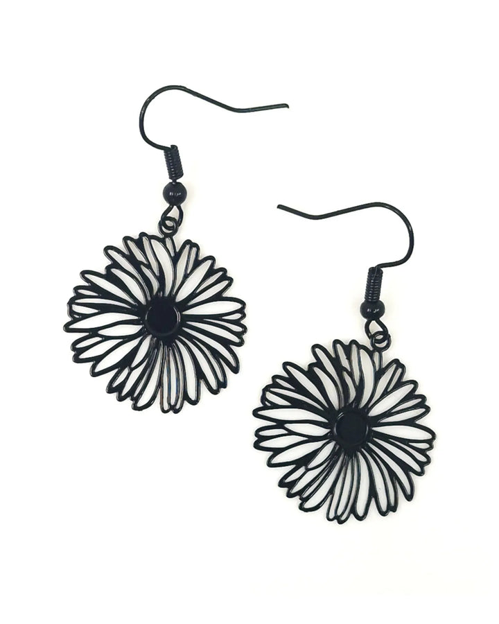 Black filigree daisy drop earrings featuring delicate metal flower design with black hooks on white background