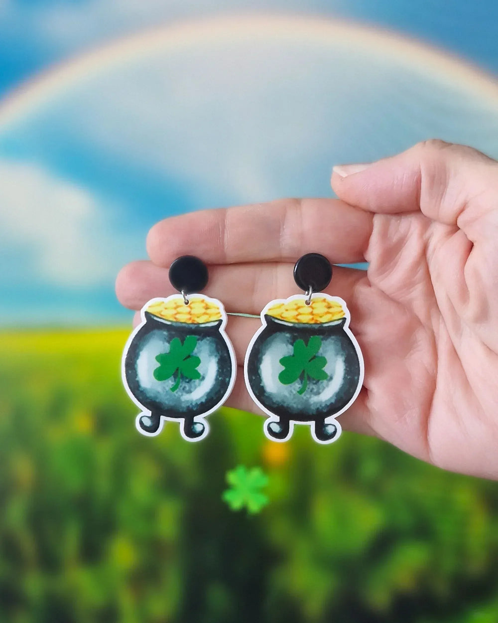 Lucky pot of gold drop earrings held in hand, showing playful St Patrick’s Day design and size