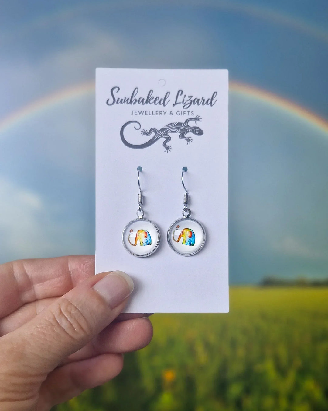 Rainbow Elephant Cabochon Drop Earrings displayed on Sunbaked Lizard jewellery card