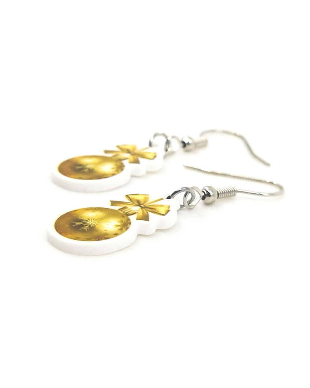 Side view of gold Christmas bauble earrings showing the flat acrylic charm printed on one side