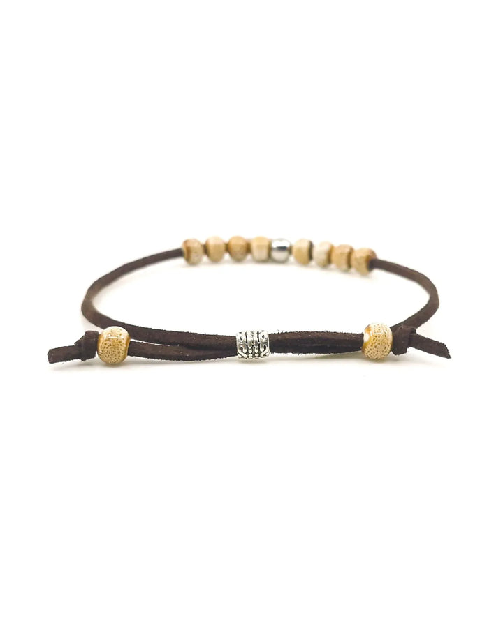 Close-up of brown Circle of Hearts charm bracelet showing ceramic beads and adjustable clasp
