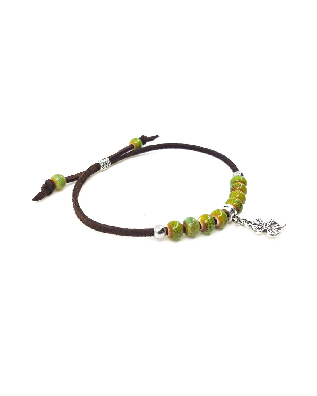 Close-up of shamrock bracelet showing silver shamrock charm and green ceramic beads