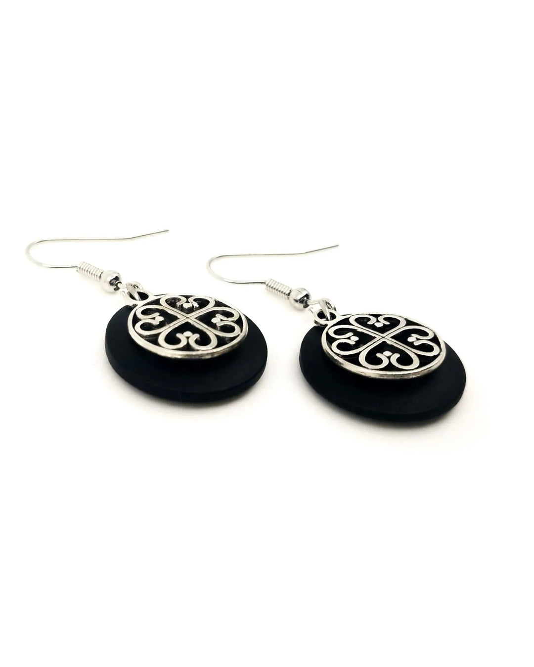 Close-up of black Circle of Hearts earrings showing heart charm details