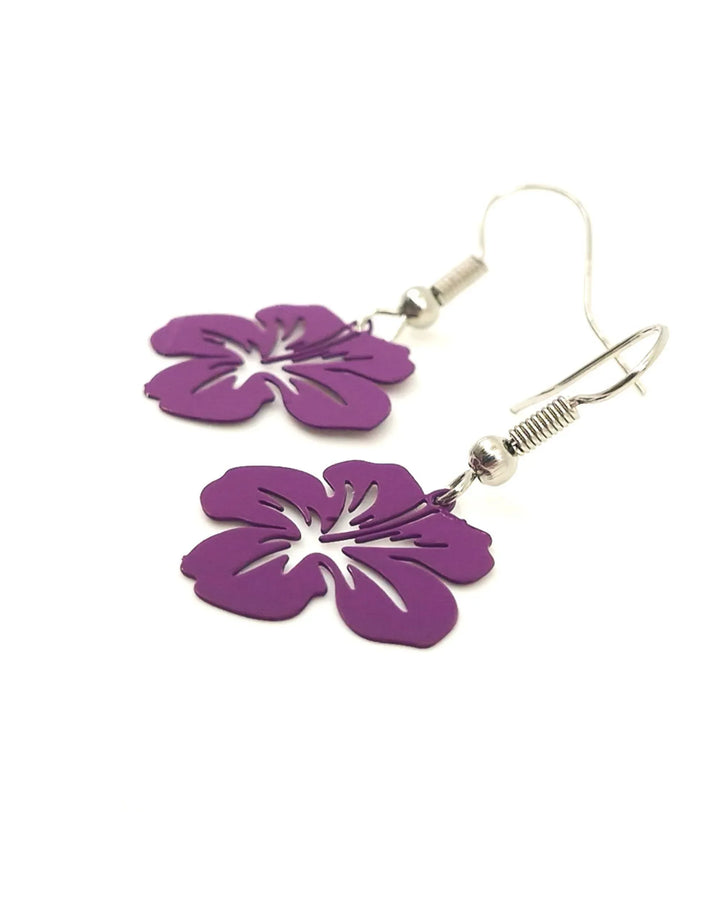 Close-up of purple filigree hibiscus earrings showing fine floral cut-out detail