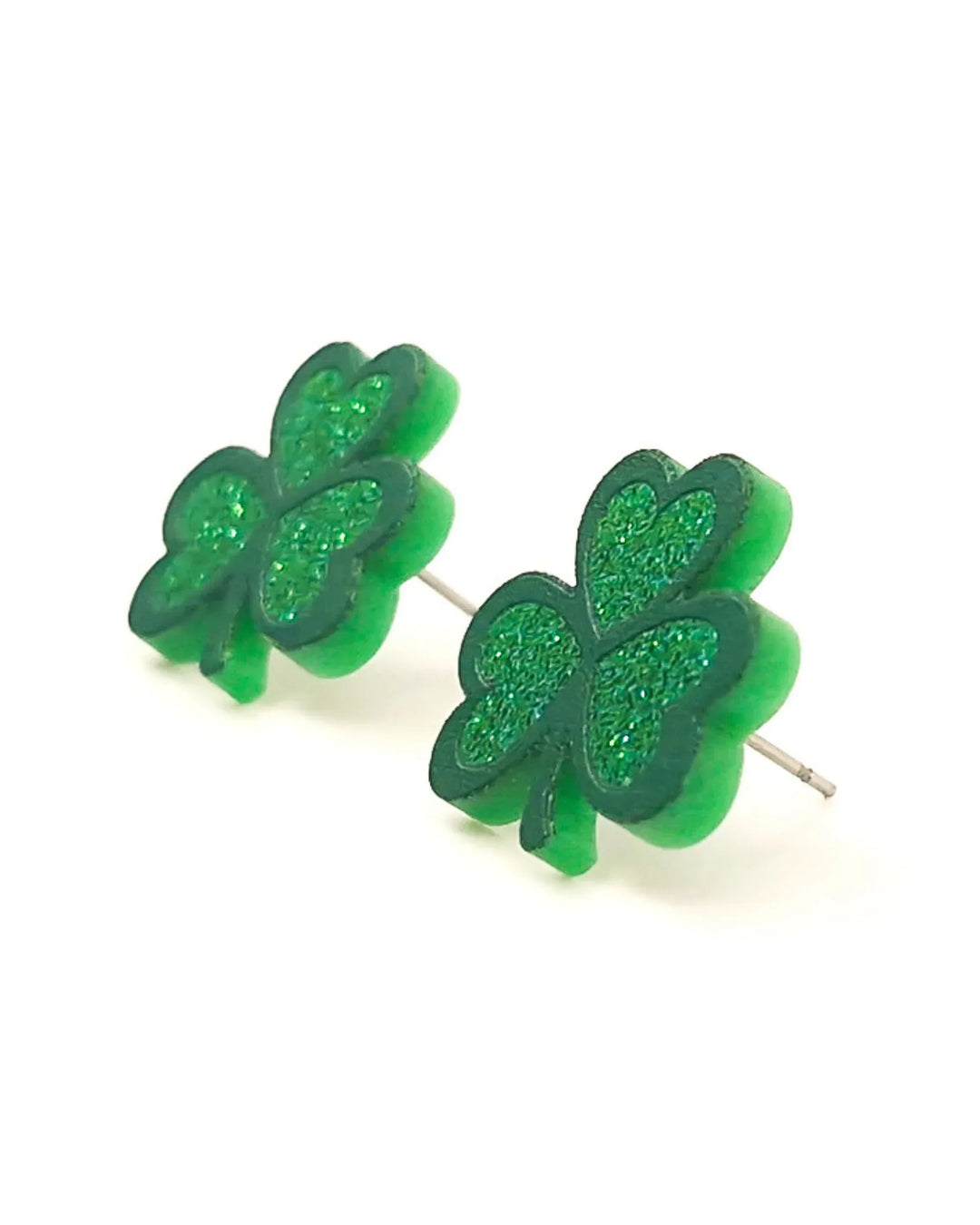 Close-up of green glitter shamrock stud earrings showing layered clover shape and glitter texture