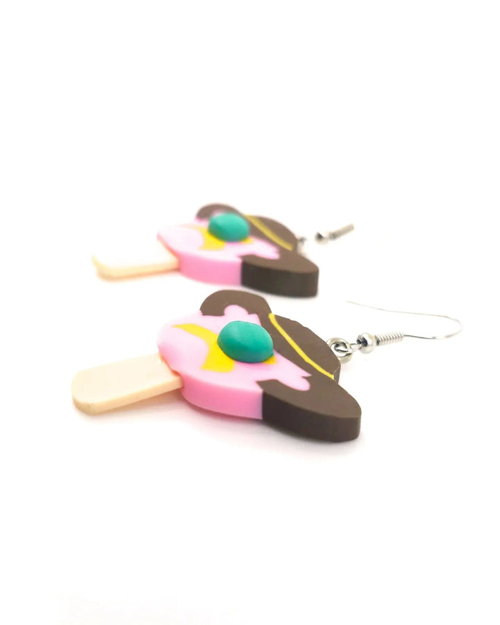 Side view of Bill ice cream drop earrings in pink and brown polymer clay with silver hooks