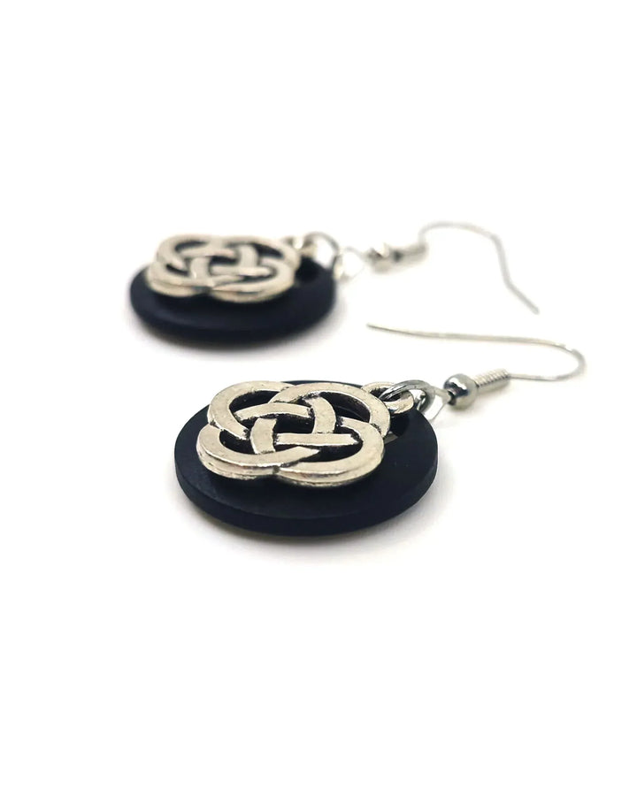 Detail of Celtic knot earrings showing layered metal and timber