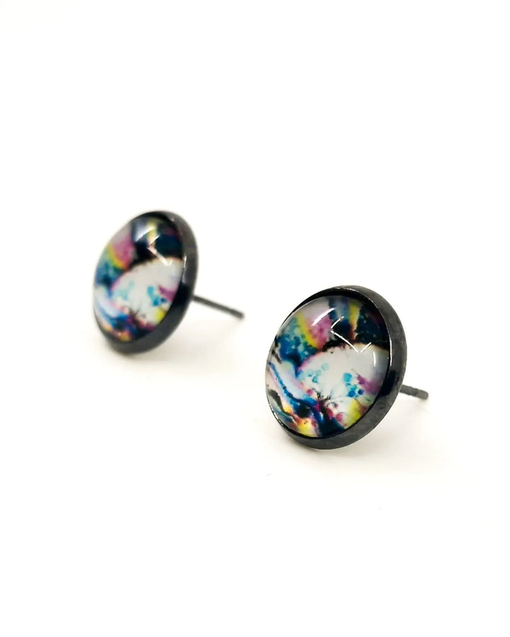 Detail view of abstract rainbow stud earrings with bold rainbow colours