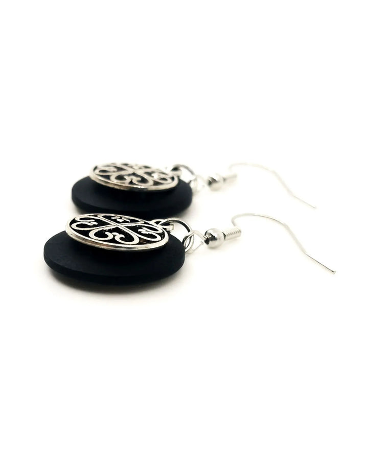 Detail view of black Circle of Hearts earrings with linked heart charms