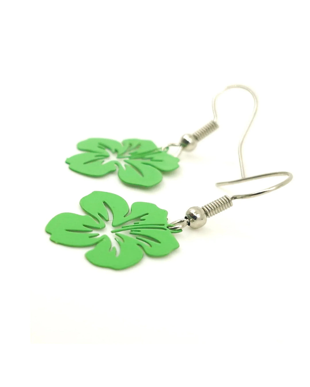 Close-up view of green filigree hibiscus earrings highlighting lightweight metal design
