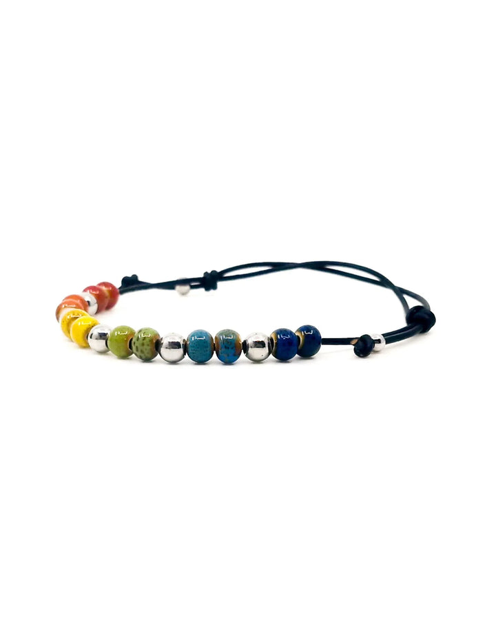 Close-up of rainbow ceramic beads on Rainbow Pride anklet