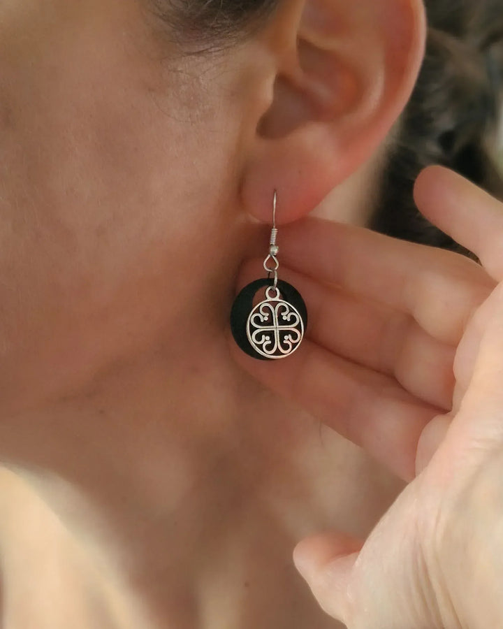 Model wearing black Circle of Hearts earrings showing size and drop length