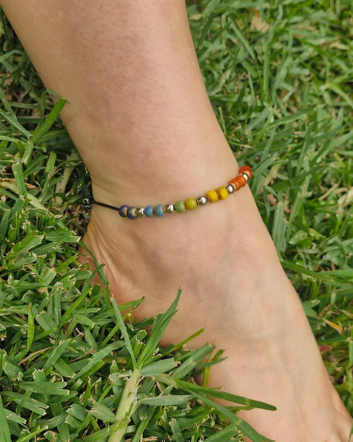 Rainbow Pride anklet worn on ankle with rainbow ceramic beads for Pride and Mardi Gras