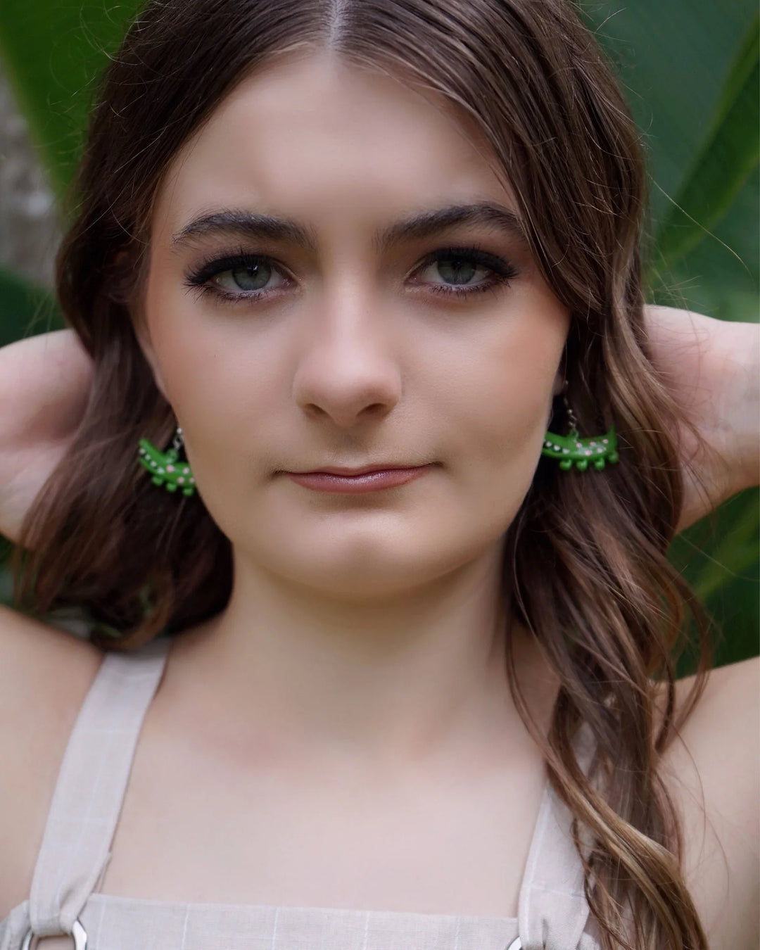 Model wearing cute green crocodile  earrings, showing size and detail of the Australiana animal design.