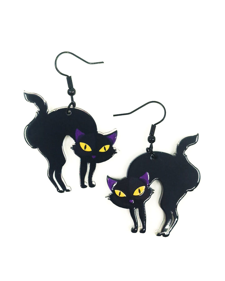 Black cat dangle earrings with arched backs, yellow eyes and black hooks on white background