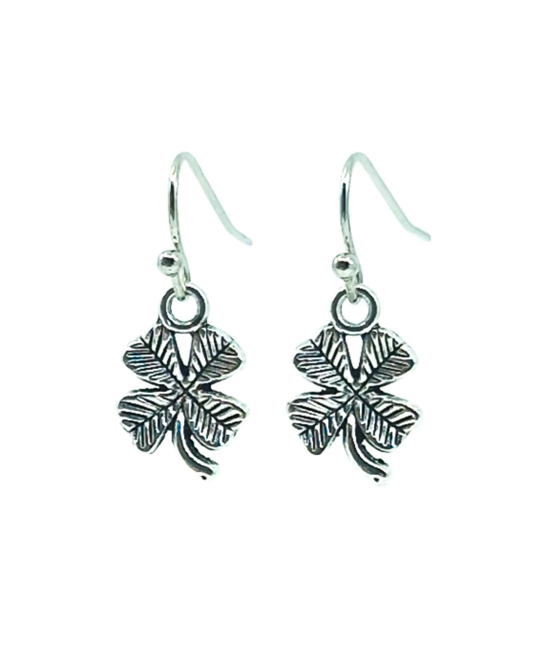 Silver shamrock charm earrings featuring a four-leaf clover design