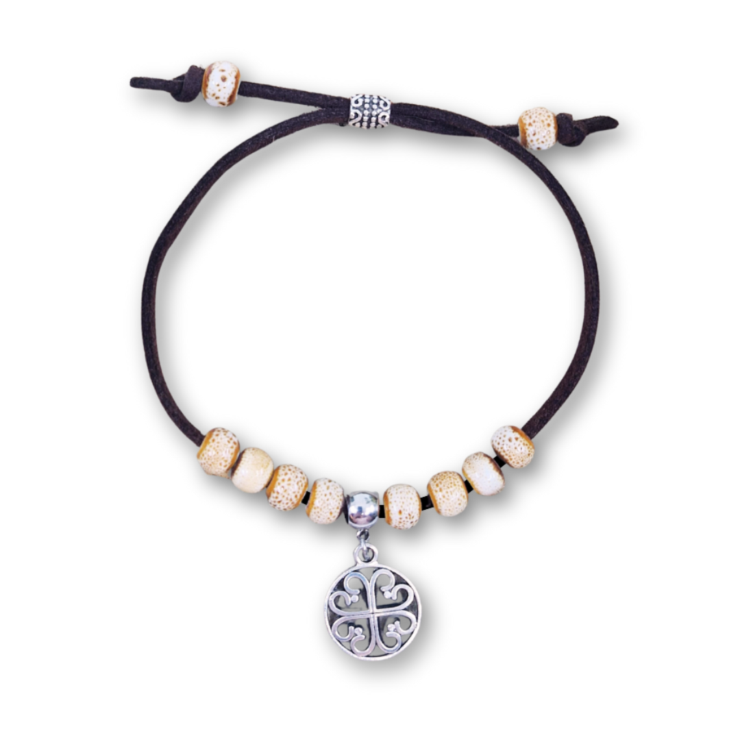 Bracelet with beads and a central charm on a white background