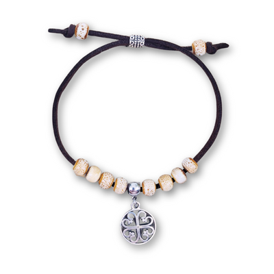 Bracelet with beads and a central charm on a white background