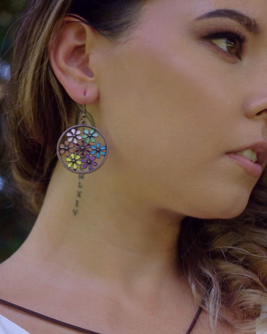 Close-up of model wearing boho copper floral earrings 
