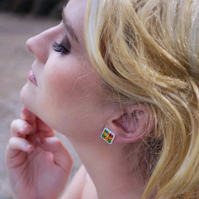 Woman wearing colourful crayon earrings outdoors
