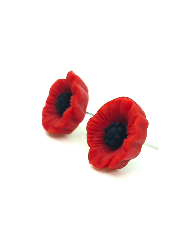 Detail view of 17mm red poppy stud earrings on a white background