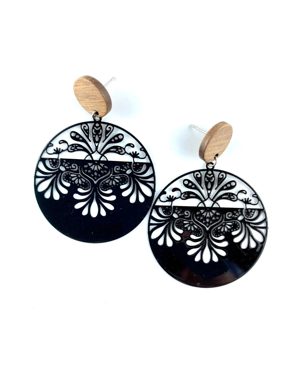 Black lacey filigree round drop earrings with timber stud top and ornate cut-out detail on white background