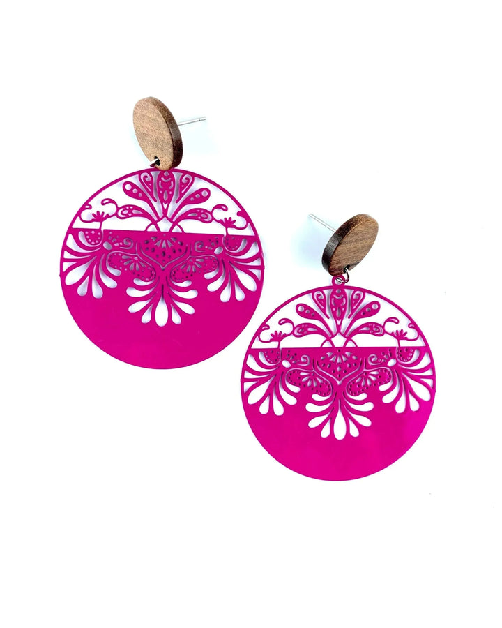 Pink lacey filigree round drop earrings with timber stud top and ornate cut-out detail on white background