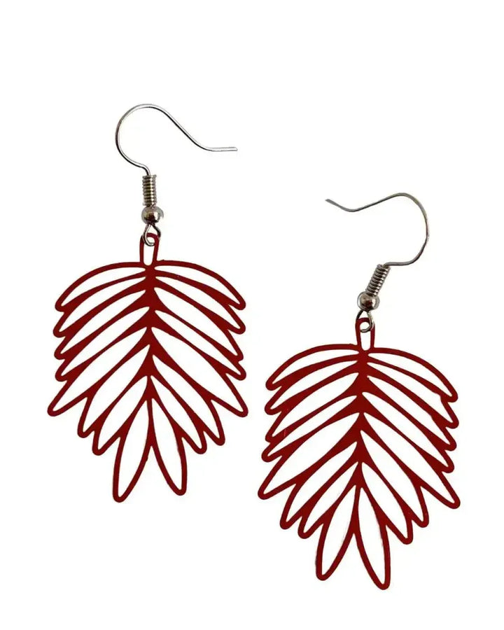 Red filigree leaf drop earrings with open leaf design and silver hooks on white background
