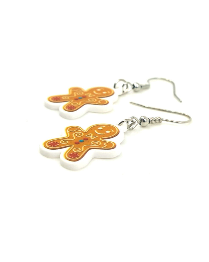 Close up photo of Gingerbread Man Christmas earrings on a white background, showing detail