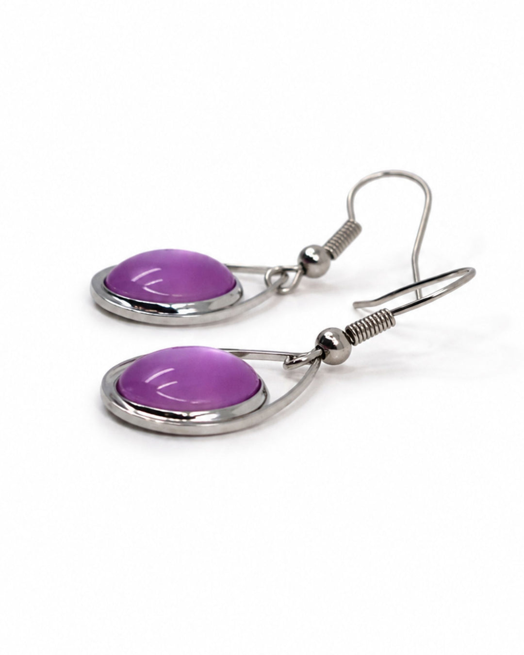 Close up view of purple glass teardrop earrings showing detail of a pearly shift across the domed charms