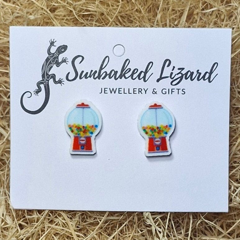 Quirky colourful gumball machine studs rest on a straw backdrop