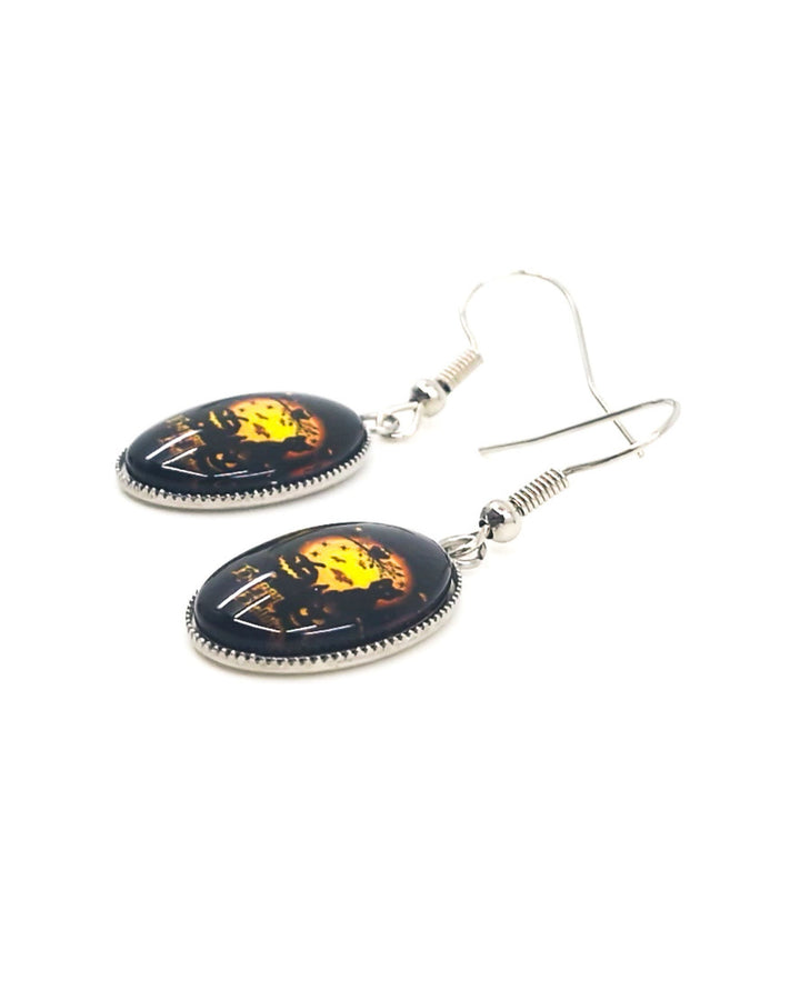 Close up of Happy Halloween oval drop earrings showing black cat and full moon design