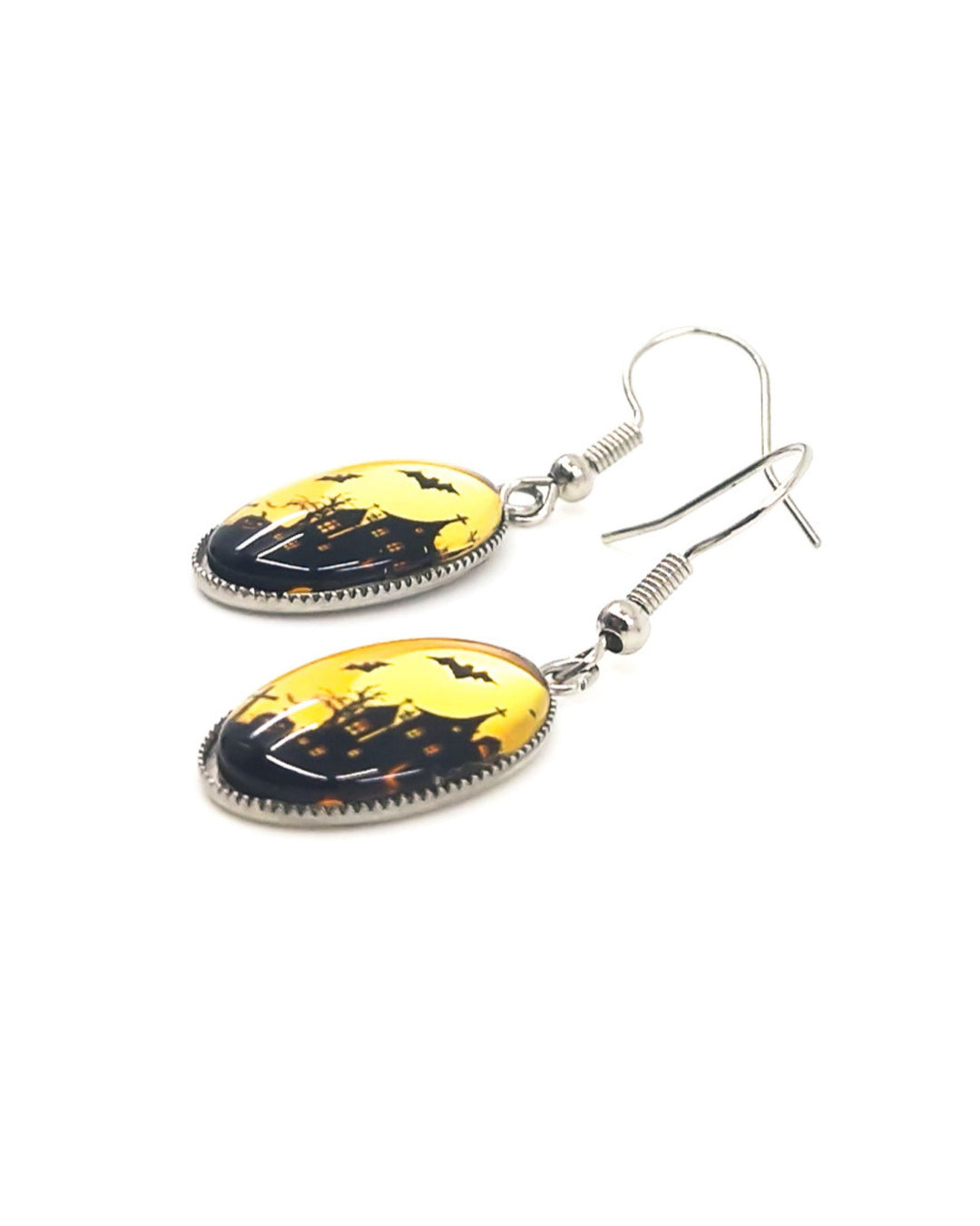 Close up of Haunted house Halloween oval drop earrings with amber moon design