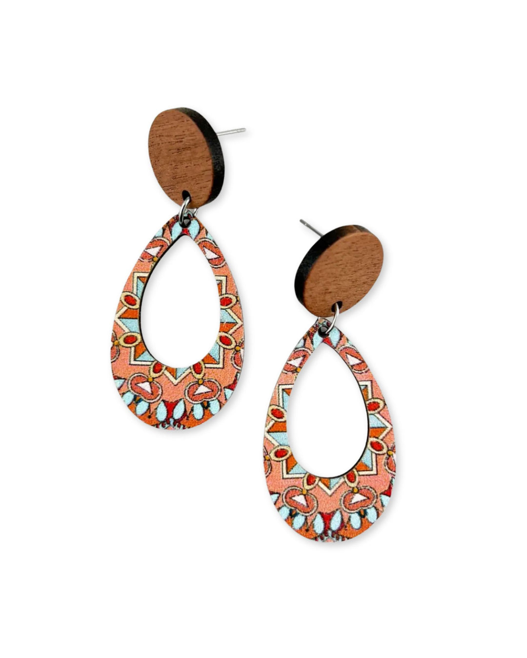 Close-up of timber oval earrings with detailed geometric kaleidoscope pattern