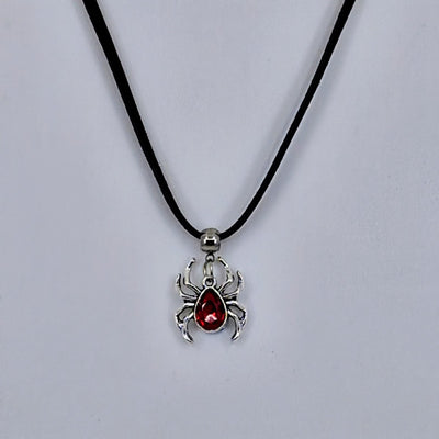 Silver spider pendant necklace with ruby-red gem-style body on black cord – creepy-cute Halloween jewellery