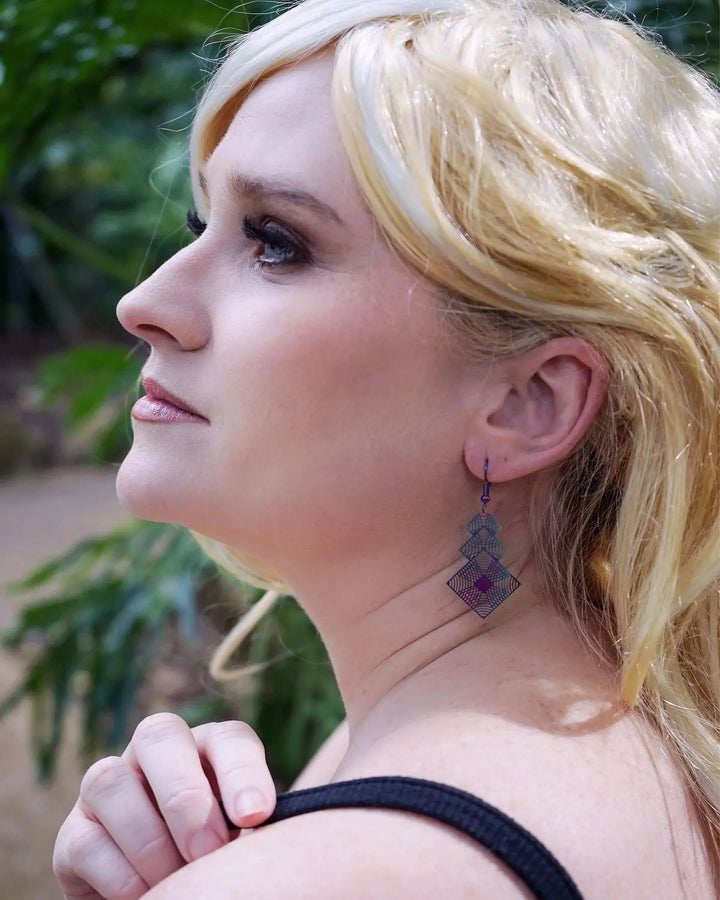 Model wearing square filigree iridescent drop earrings with lightweight geometric design by Sunbaked Lizard