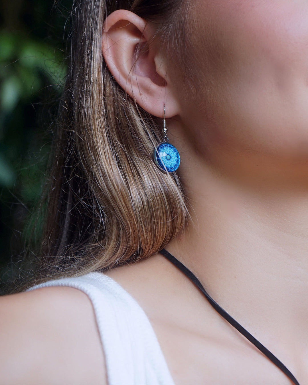 Close-up of model wearing Sunbaked Lizard Blue Mandala Earrings 