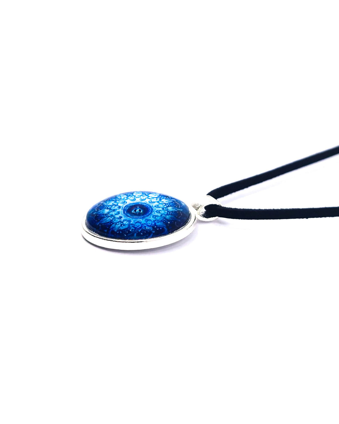 Detail view of blue mandala necklace with glossy glass cabochon pendant on soft black cord