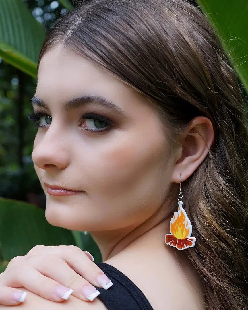 Side view of a model wearing the orange campfire flame dangle earring, showing the vibrant acrylic detail