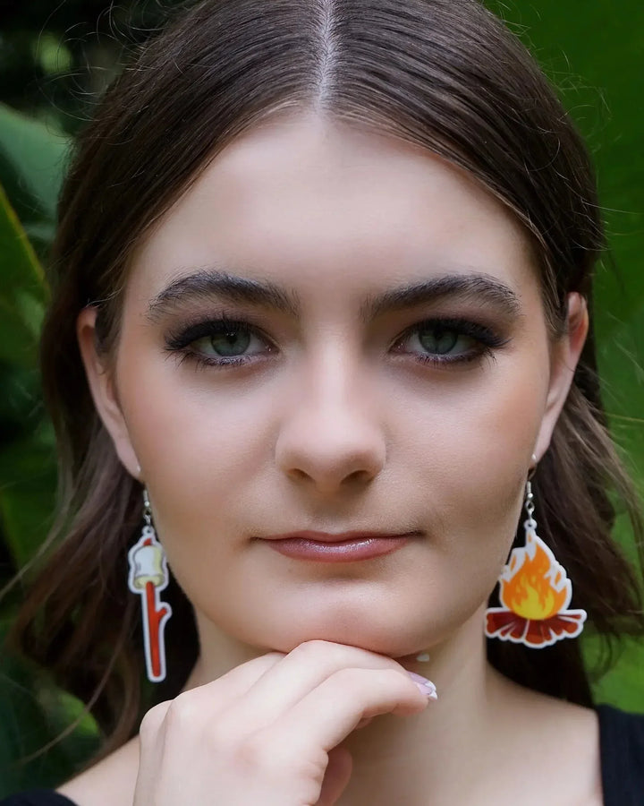 Front view of a model wearing the Marshmallows by the Campfire Dangle Earrings, showing both the marshmallow and campfire charms.