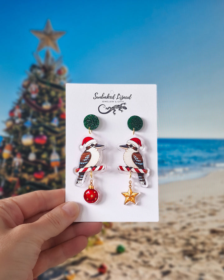 Christmas kookaburra earrings with green glitter tops, Santa hats, candy cane perches and festive hanging charms.