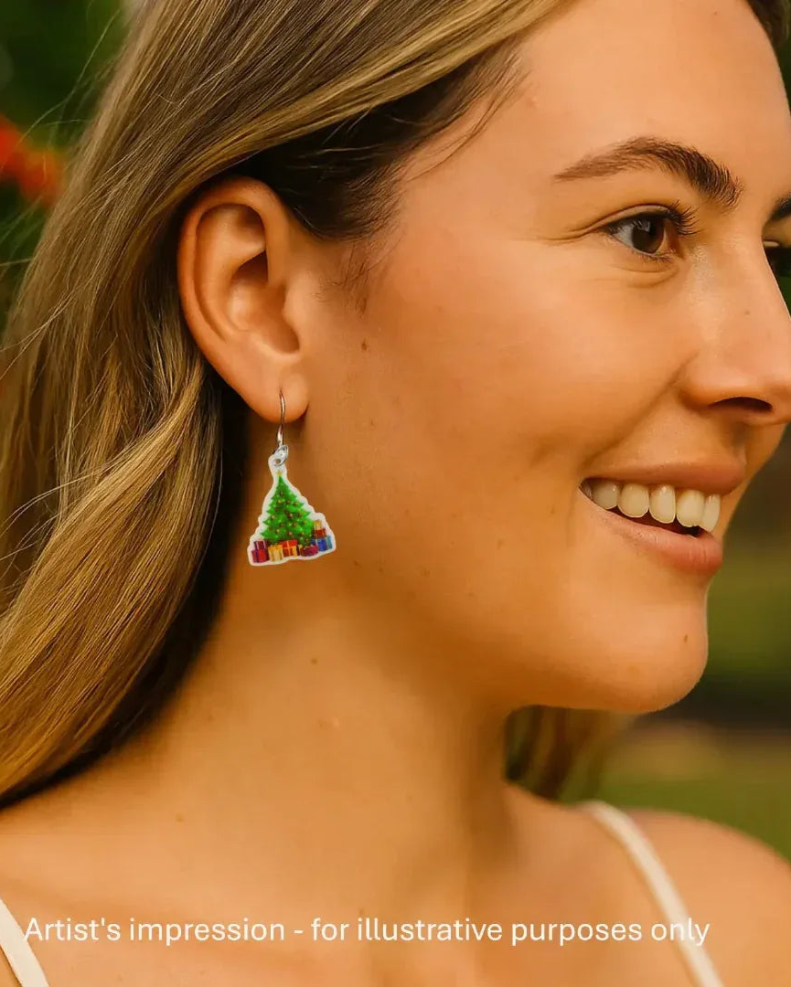 Model wearing a Christmas tree earring with presents underneath, showing the size against her ear