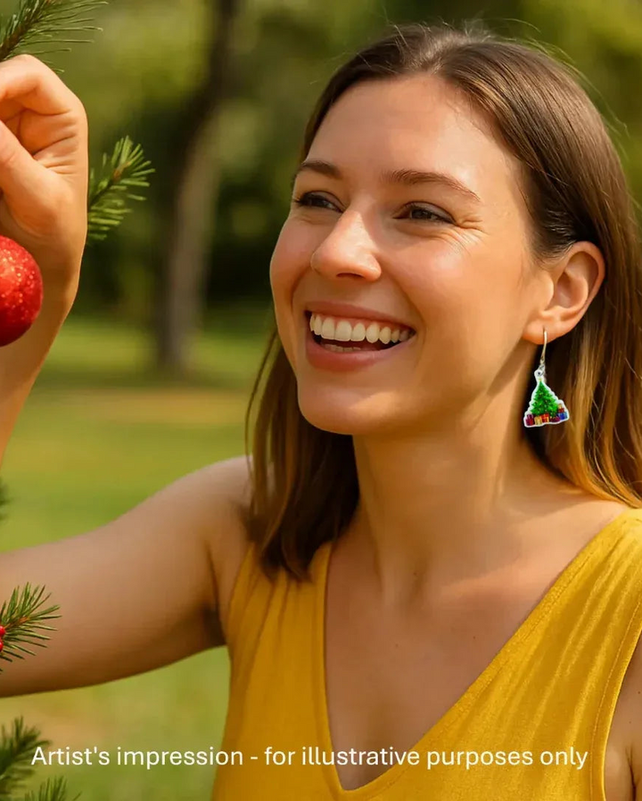 Model wearing a Christmas tree earring with presents underneath, showing the size against her ear