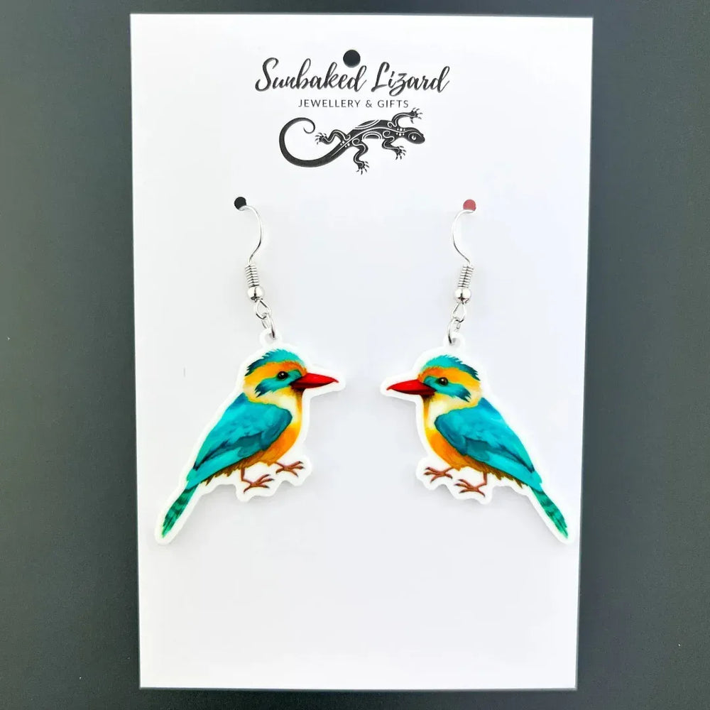 Colourful kingfisher drop earrings, two mirrored turquoise and orange birds with red beaks on silver hooks on Sunbaked Lizard backing card