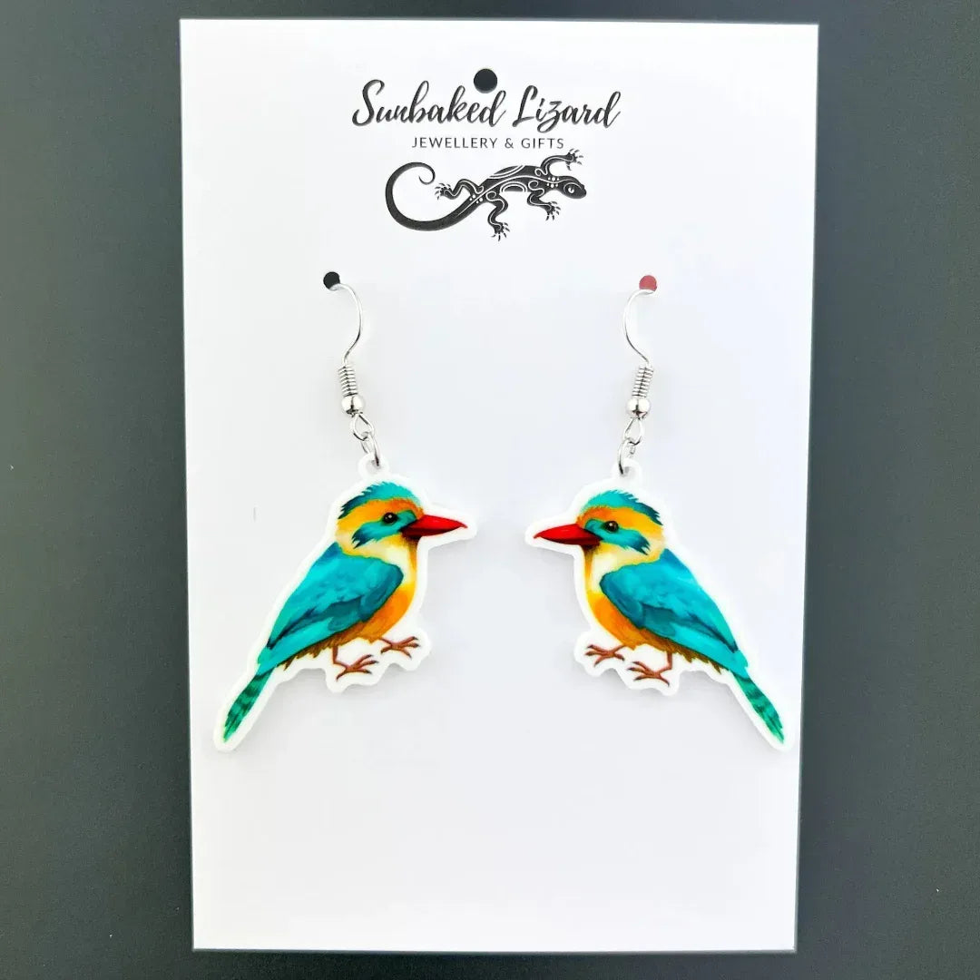 Colourful kingfisher drop earrings, two mirrored turquoise and orange birds with red beaks on silver hooks on Sunbaked Lizard backing card