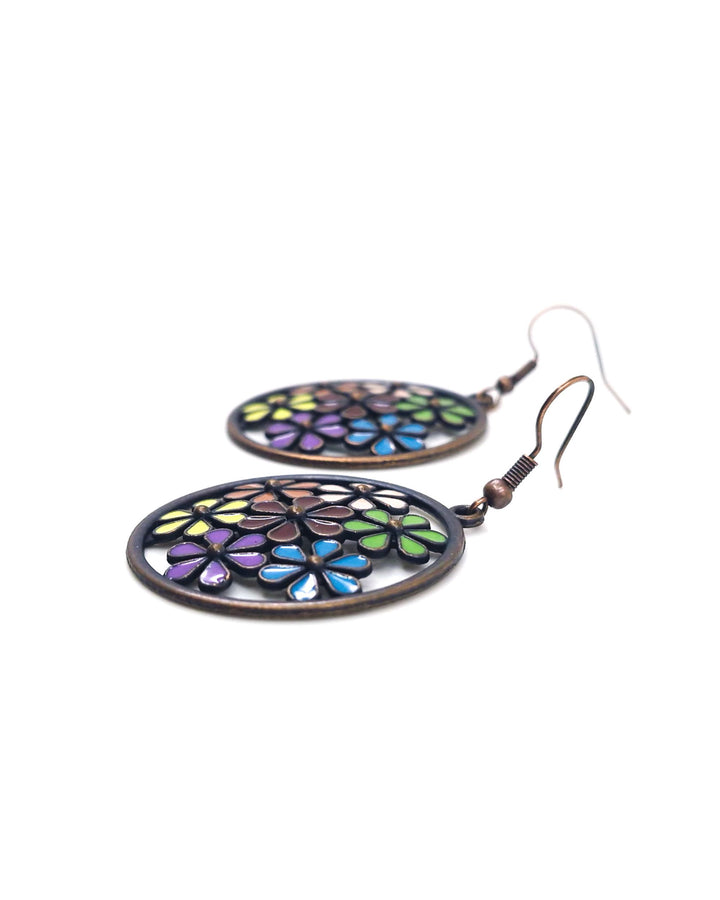 Side view of round antique-copper drop earrings with a colourful enamel flower mosaic design