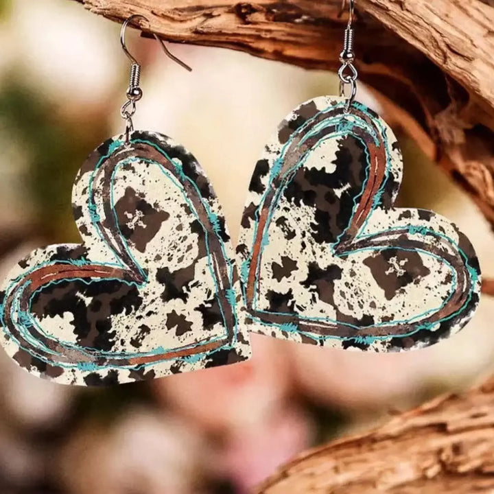 Cow print leather heart earrings hanging, western and country inspired jewellery