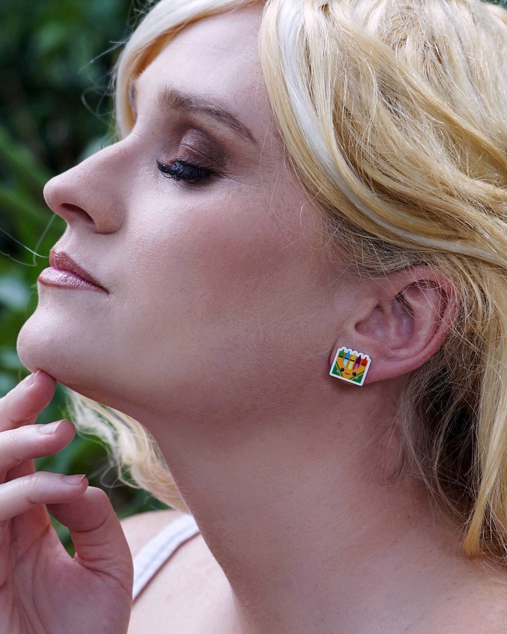 Close-up of colourful crayon novelty stud earrings