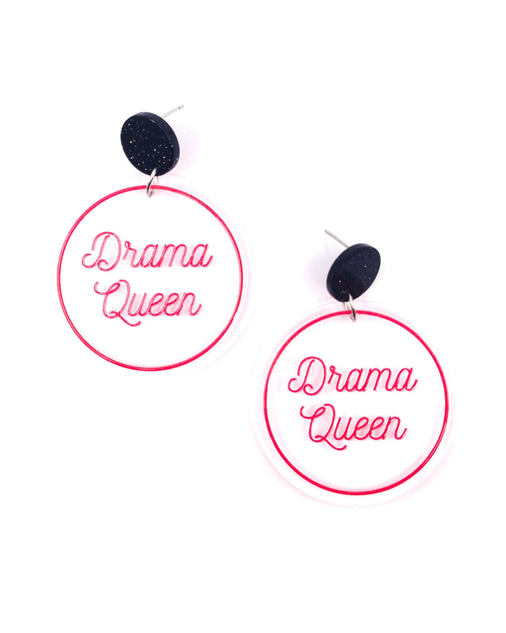 Drama Queen acrylic statement earrings with pink lettering on clear round drops and black glitter studs.